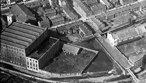 Aerial view about 1933 showing, Shepley Mill bottom left with the Big Wesley above and the Electric Palace, George Street footbridge and Gloveworks to the right